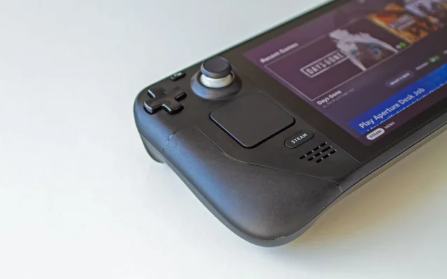 Detaliu al unei console Steam Deck negre, cu biblioteca de jocuri pe ecran
