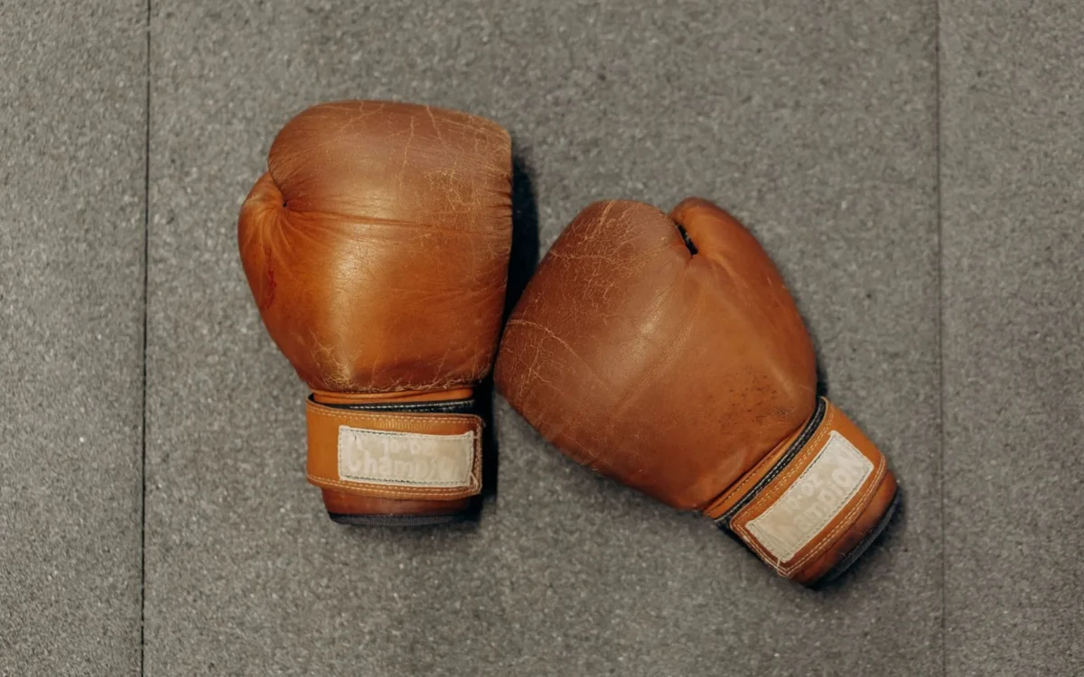Pereche de mănuși maro de box pe o suprafață gri
